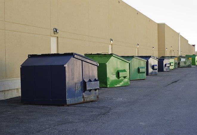 a group of construction workers taking a break near a dumpster in Aspen Hill